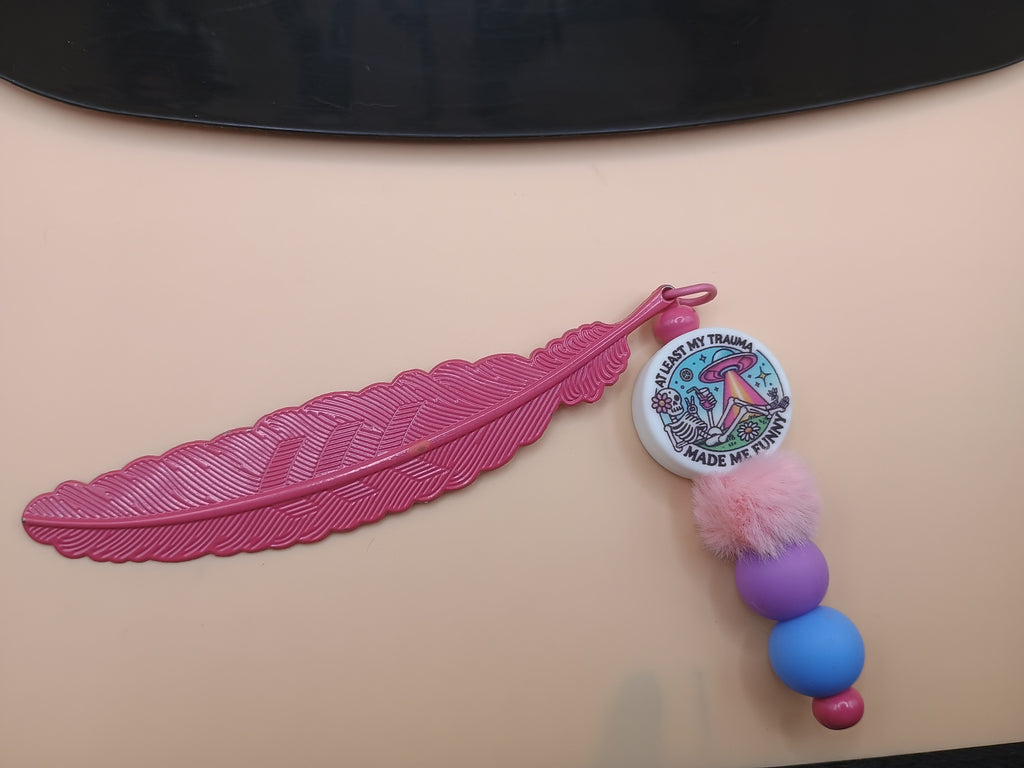 “Trauma Made Me Funny” Skeleton Space Feather Bookmark – Pink Metal Beaded Bookmark