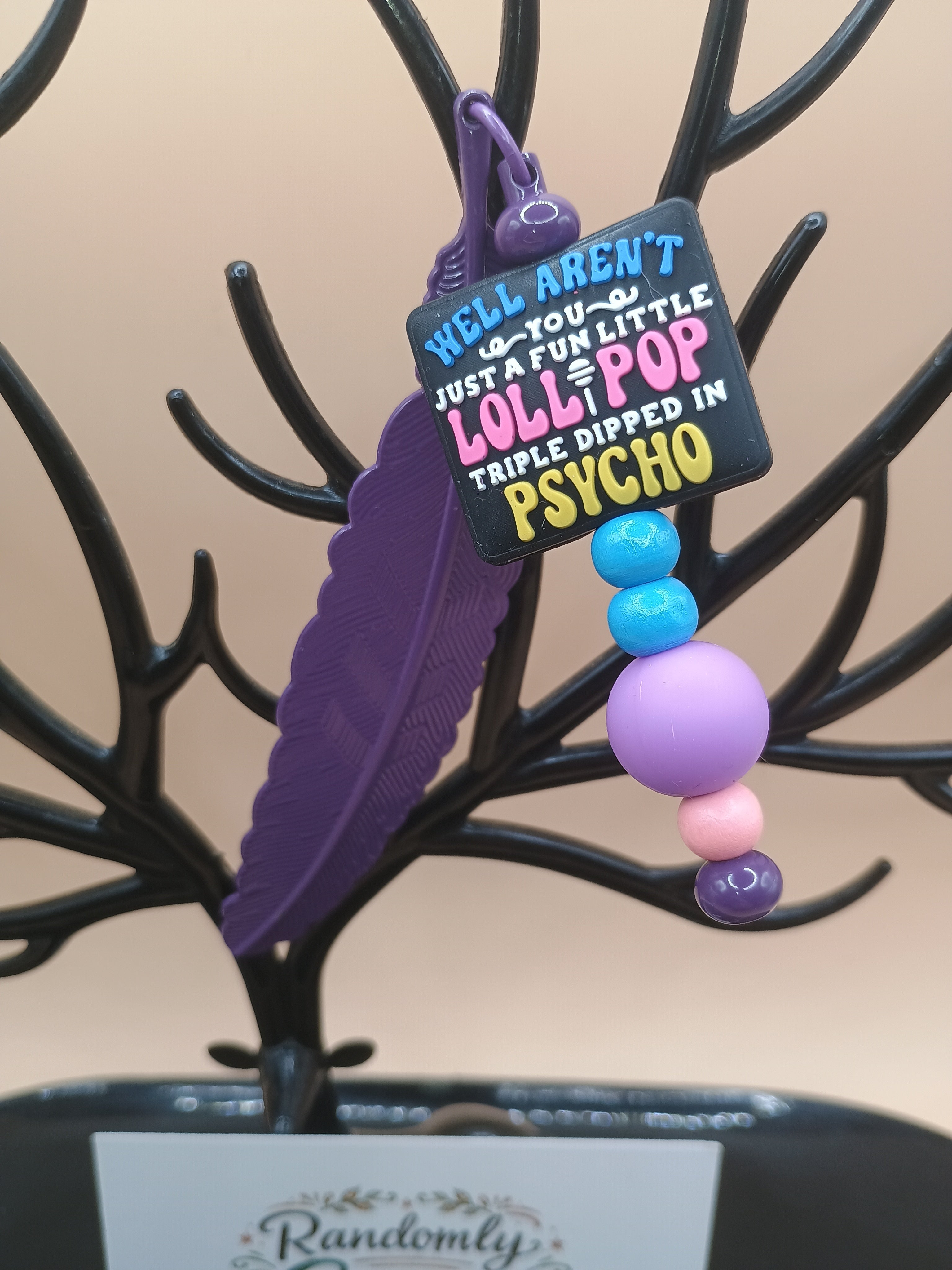 “Fun Little Lollipop Triple Dipped in Psycho” Feather Bookmark – Purple Metal Beaded Bookmark