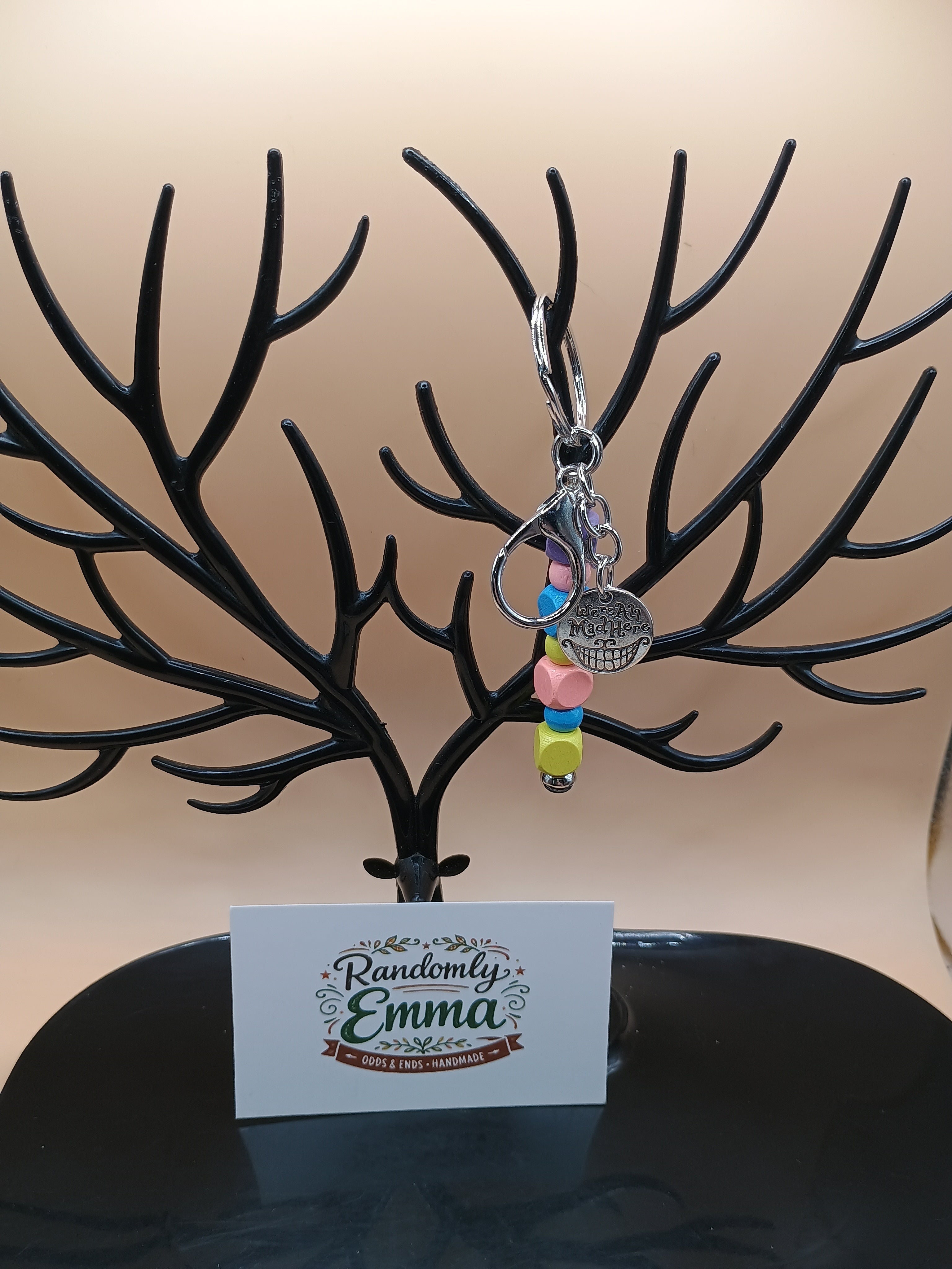 “We’re All Mad Here” Beaded Keychain – Silver Metal Keychain with Cheshire Smile Charm