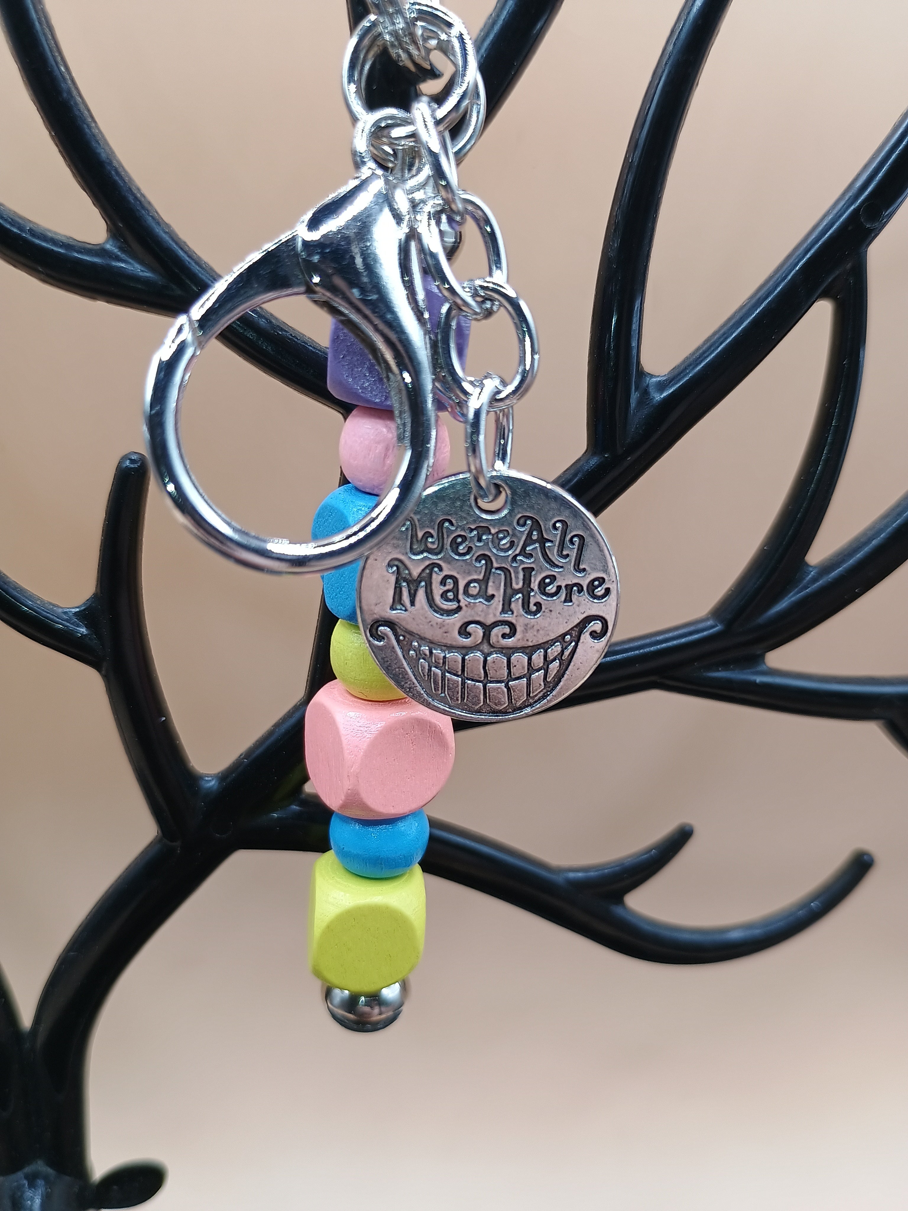“We’re All Mad Here” Beaded Keychain – Silver Metal Keychain with Cheshire Smile Charm